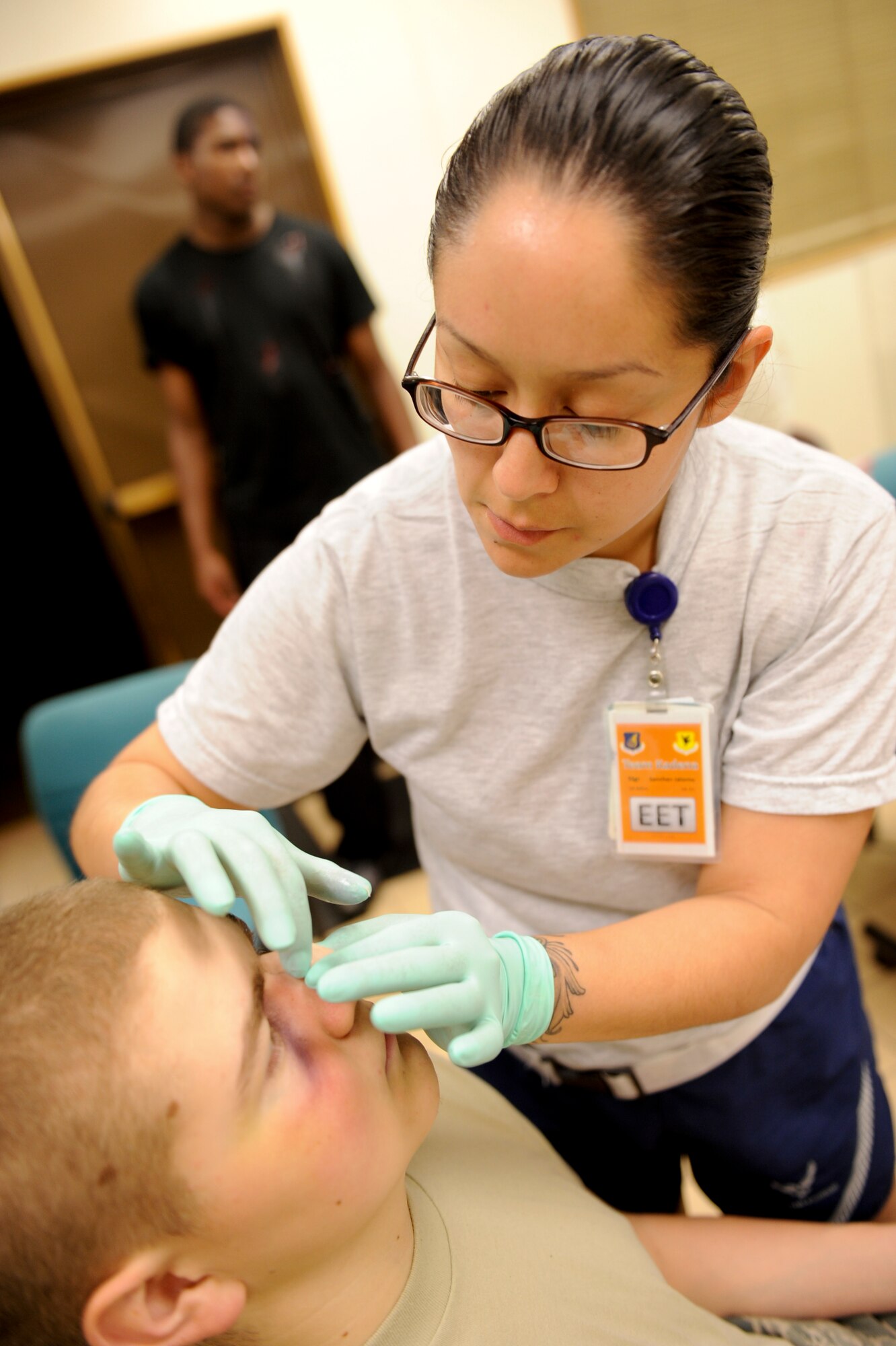 U.S. Air Force Staff Sgt. Jalomo Sanchez, 18th Dental Squadron dental lab technician, applies stage makeup to U.S. Air Force Airman Brice Ohrt, 18th Aircraft Maintenance Squadron, to simulate injuries and provide a more realistic training environment during local operational readiness exercise Beverly High 12-4 on Kadena Air Base, Japan, May 16, 2012. LOREs are designed to test, train and evaluate the base's ability to respond to a contingency in the region. (U.S. Air Force photo/ Airman 1st Class Brooke P. Beers)