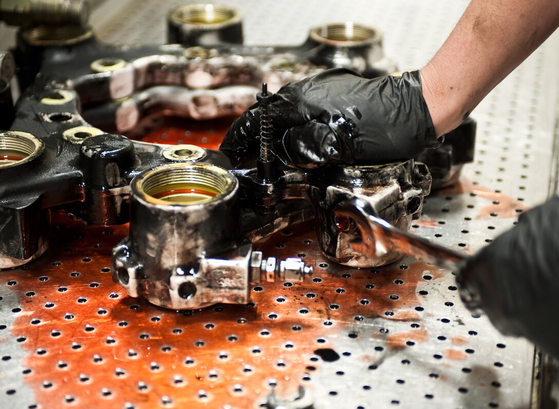 Airman 1st Class Conner Tolley, 28th Maintenance Squadron hydraulics technician, removes “bleeding” parts from a brake housing during disassembly at Ellsworth Air Force Base, S.D., May 11, 2012. The 28th MXS pneudraulics shop is responsible for the maintenance of all hydraulic system components on the base’s fleet of B-1 bombers. (U.S. Air Force photo by Airman 1st Class Alystria Maurer/Released)