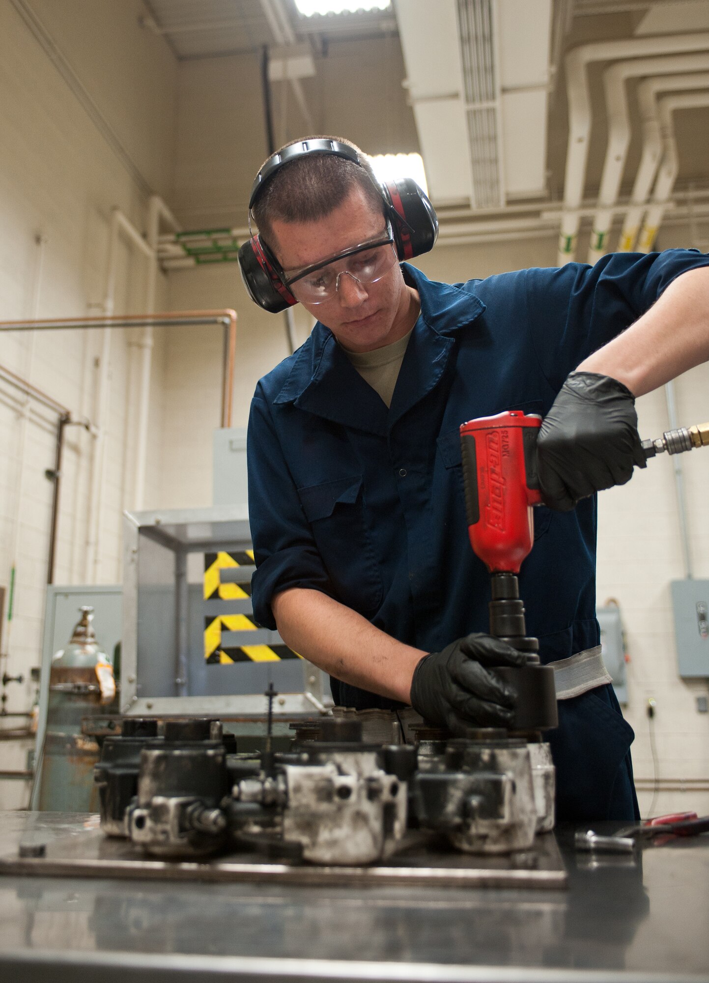Airman 1st Class Conner Tolley, 28th Maintenance Squadron hydraulics technician, loosens brake housing pistons during disassembly at Ellsworth Air Force Base, S.D., May 11, 2012. When any problems occur with B-1 brake systems, they are disassembled, inspected, fixed, reassembled and extensively tested before being reinstalled. (U.S. Air Force photo by Airman 1st Class Alystria Maurer/Released)