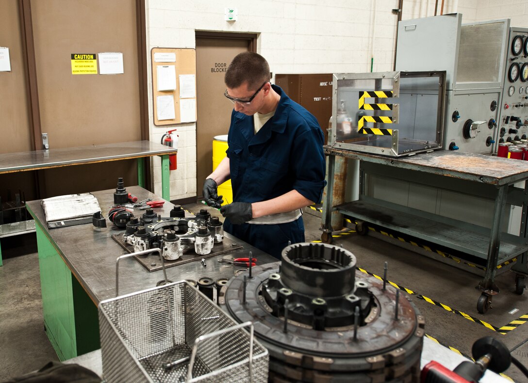 Airman 1st Class Conner Tolley, 28th Maintenance Squadron hydraulics technician, removes safety wire from a brake housing during disassembly at Ellsworth Air Force Base, S.D., May 11, 2012. Ellsworth maintainers build and maintain various hydraulic components that keep Ellsworth’s B-1 bomber fleet mission capable. (U.S. Air Force photo by Airman 1st Class Alystria Maurer/Released)