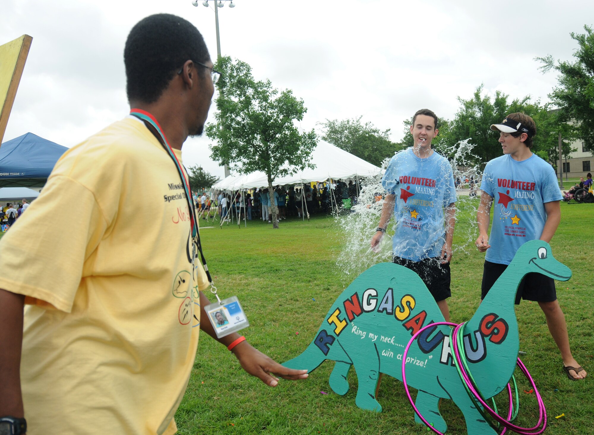 Alonzo Gaddy, athlete, busts a balloon on volunteers Jarrett Helm and Colby Jones, 16, son of Steve Jones, also a volunteer from Ingalls Ship Building in Pascagoula, Miss., while playing a game at Olympic Village during the Special Olympics Deloris Reed, athlete, is assisted by her Airman sponsor, Airman Jacqueline Brewer, 336th Training Squadron, with choosing beads to make a necklace at Olympic Village during the Special Olympics Mississippi Summer Games, May 12, 2012, at Keesler Air Force Base, Miss. It’s the 26th year that Keesler has hosted the statewide event. Opening ceremonies took place May 11. Athletic competitions took place throughout the day and were followed by a victory dance May 12. More than 1,200 athletes and coaches and 3,000 volunteers joined forces to make the event a success. Olympic Village is an area set up on the parade field with vendors, arts and crafts, games and karaoke for entertaining the athletes while not competing.  (U.S. Air Force photo by Kemberly Groue)