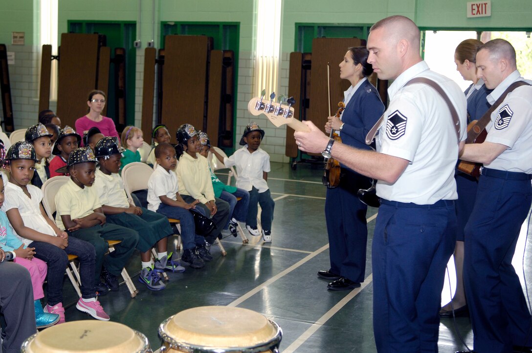 Senior Master Sgt. Matt Ascione and Technical Sgts. Joseph Haughton, Emily Lewis and Julia Brundage perform for students at Leckie Elementary School's Career Day in Washington, D.C.  (U.S. Air Force photo by Senior Airman Steele Britton)