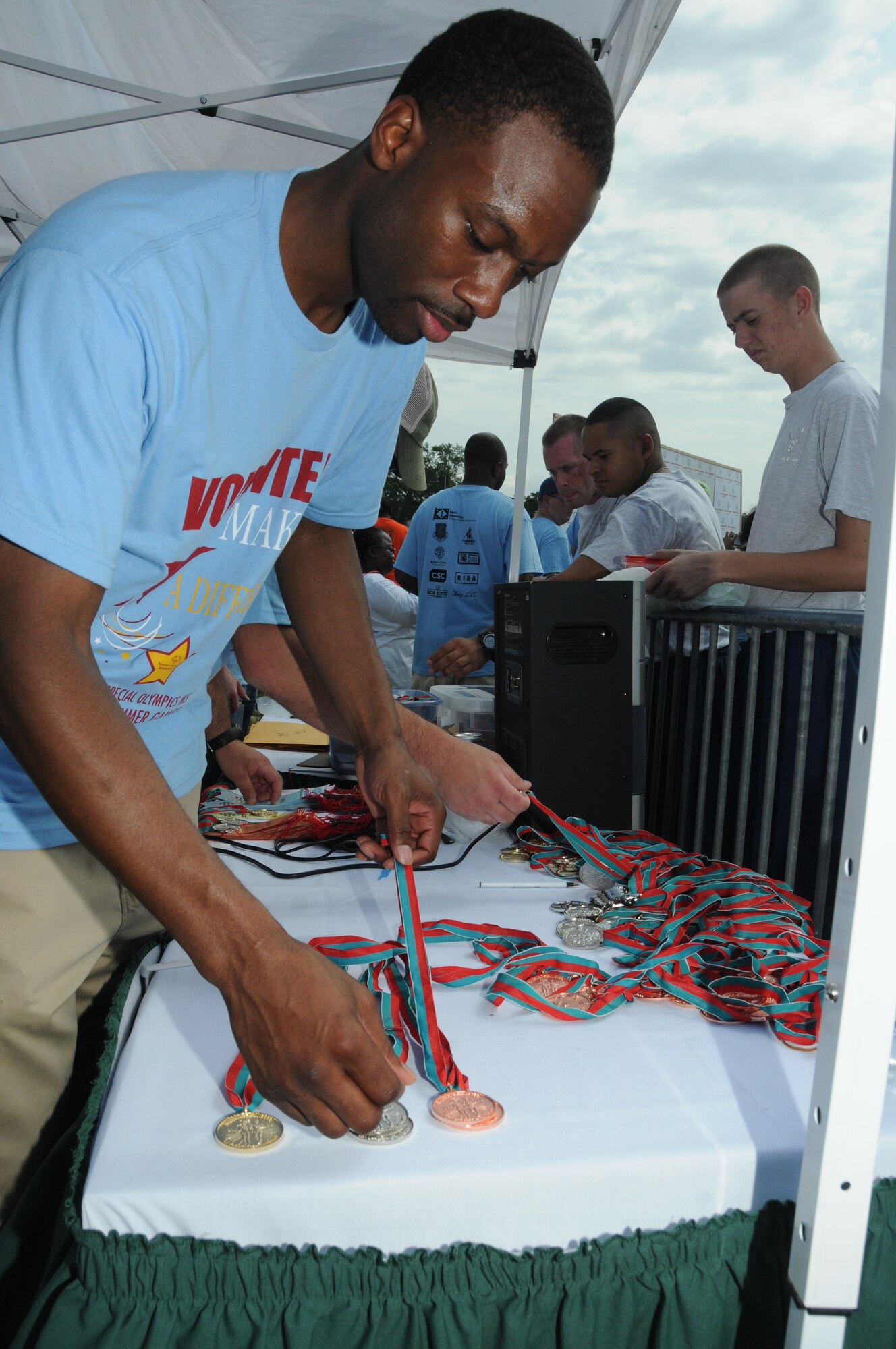 Tech Sgt. Rodrick Greene, Mathies NCO Academy, volunteers his services by sorting and presenting medals during the Special Olympics Mississippi Summer Games, May 12, 2012, at Keesler Air Force Base, Miss. It’s the 26th year that Keesler has hosted the statewide event. Opening ceremonies took place May 11. Athletic competitions took place throughout the day and were followed by a victory dance May 12. More than 1,200 athletes and coaches and 3,000 volunteers joined forces to make the event a success.  (U.S. Air Force photo by Kemberly Groue)