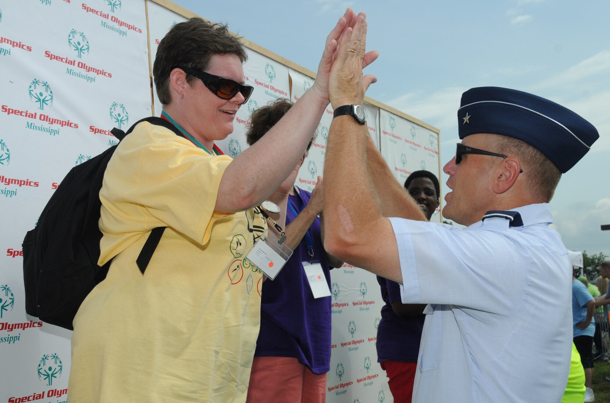 Cassie McLeod, athlete, receives a high-five from Brig. Gen. Andrew Mueller, 81st Training Wing commander, after he presented her with a silver medal during the Special Olympics Mississippi Summer Games, May 12, 2012, at Keesler Air Force Base, Miss. It’s the 26th year that Keesler has hosted the statewide event. Opening ceremonies took place May 11. Athletic competitions took place throughout the day and were followed by a victory dance May 12. More than 1,200 athletes and coaches and 3,000 volunteers joined forces to make the event a success.  (U.S. Air Force photo by Kemberly Groue)