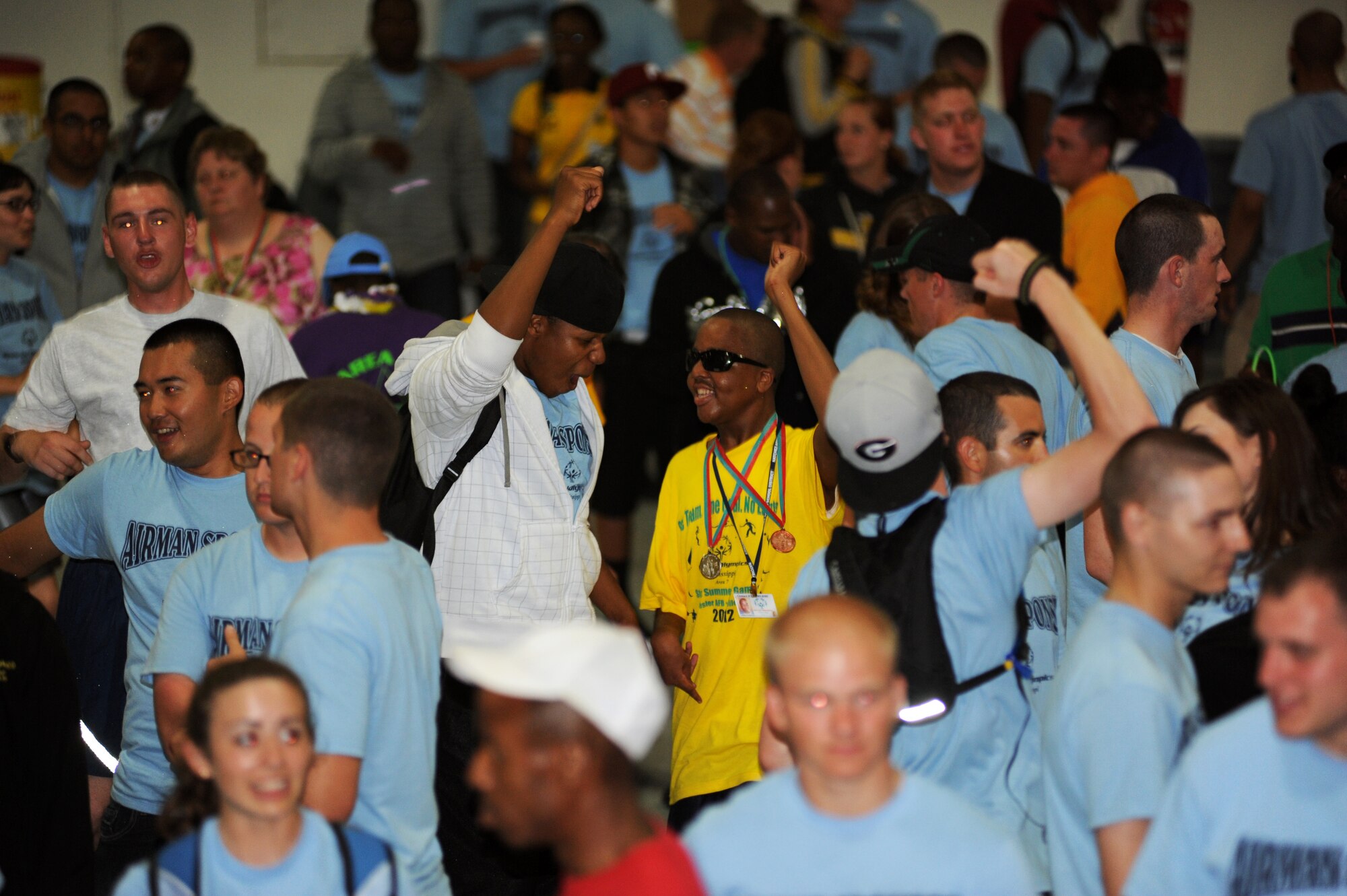 Airman 1st Class Eric Williams, 338th Training Squadron, dances with his sponsored athlete, James Stampley, 17, during the victory dance inside a hangar, following closing ceremonies and ending the Special Olympics Mississippi Summer Games, May 12, 2012, at Keesler Air Force Base, Miss. It’s the 26th year that Keesler has hosted the statewide event. Opening ceremonies took place May 11. Athletic competitions took place throughout the day and were followed by the victory dance. More than 1,200 athletes and coaches and 3,000 volunteers joined forces to make the event a success.  (U.S. Air Force photo by Kemberly Groue)