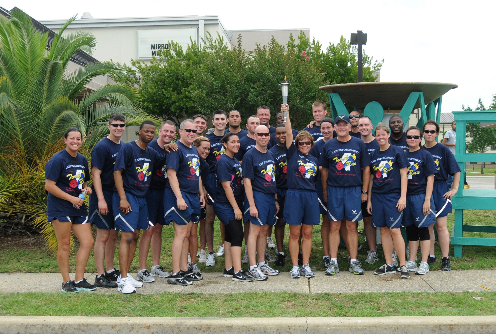 Brig. Gen. Andrew Mueller, 81st Training Wing commander, Chief Master Sgt. Angelica Johnson, 81 TRW command chief, and Col. Glen Downing, 81 TRW vice commander, carried the “Flame of Hope” accompanied by runners from the 81st Security Forces Squadron in preparation for the Special Olympics Mississippi Summer Games, May 11, 2012, at Keesler Air Force Base, Miss. It’s the 26th year that Keesler has hosted the statewide event. Opening ceremonies took place May 11. Athletic competitions took place throughout the day and were followed by a victory dance May 12. More than 1,200 athletes and coaches and 3,000 volunteers joined forces to make the event a success.  (U.S. Air Force photo by Kemberly Groue)
