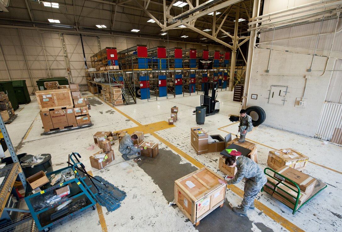 Members of the 28th Logistics Readiness Squadron aircraft parts store perform box maintenance during package processing at Ellsworth Air Force Base, S.D., May 9, 2012. The 28th LRS aircraft parts store maintains an inventory of parts for maintenance, as well as for parts shipped to deployed locations. (U.S. Air Force photo by Airman 1st Class Alystria Maurer/Released)