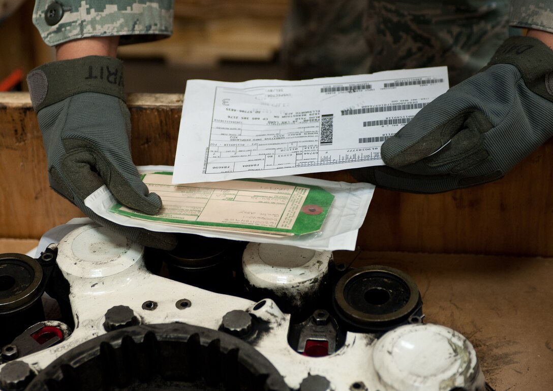 Senior Airman Joyce Dayrit, 28th Logistics Readiness Squadron supply technician, checks a part number against a service tag during package inspections at Ellsworth Air Force Base, S.D., May 8, 2012. Before parts are sent to their intended destinations they are inspected to verify the order and ensure the quantity of parts is correct. (U.S. Air Force photo by Airman 1st Class Alystria Maurer/Released)