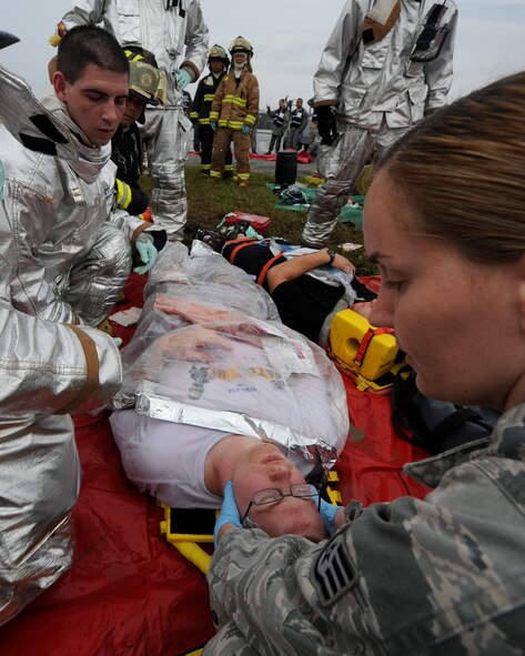 Airmen from the 18th Medical Group and firefighters from the 18th Civil Engineer Squadron care for simulated wounded personnel during an emergency management exercise (EME) taking place during local operational readiness exercise Beverly High 12-4 on Kadena Air Base, Japan, May 16, 2012. Evaluations like this EME will be taking place all week to test the skills and knowledge of Kadena’s Airmen to ensure they are ready to respond to contingencies throughout the Pacific command. (U.S Air Force photo/Staff Sgt. Laszlo Babocsi)