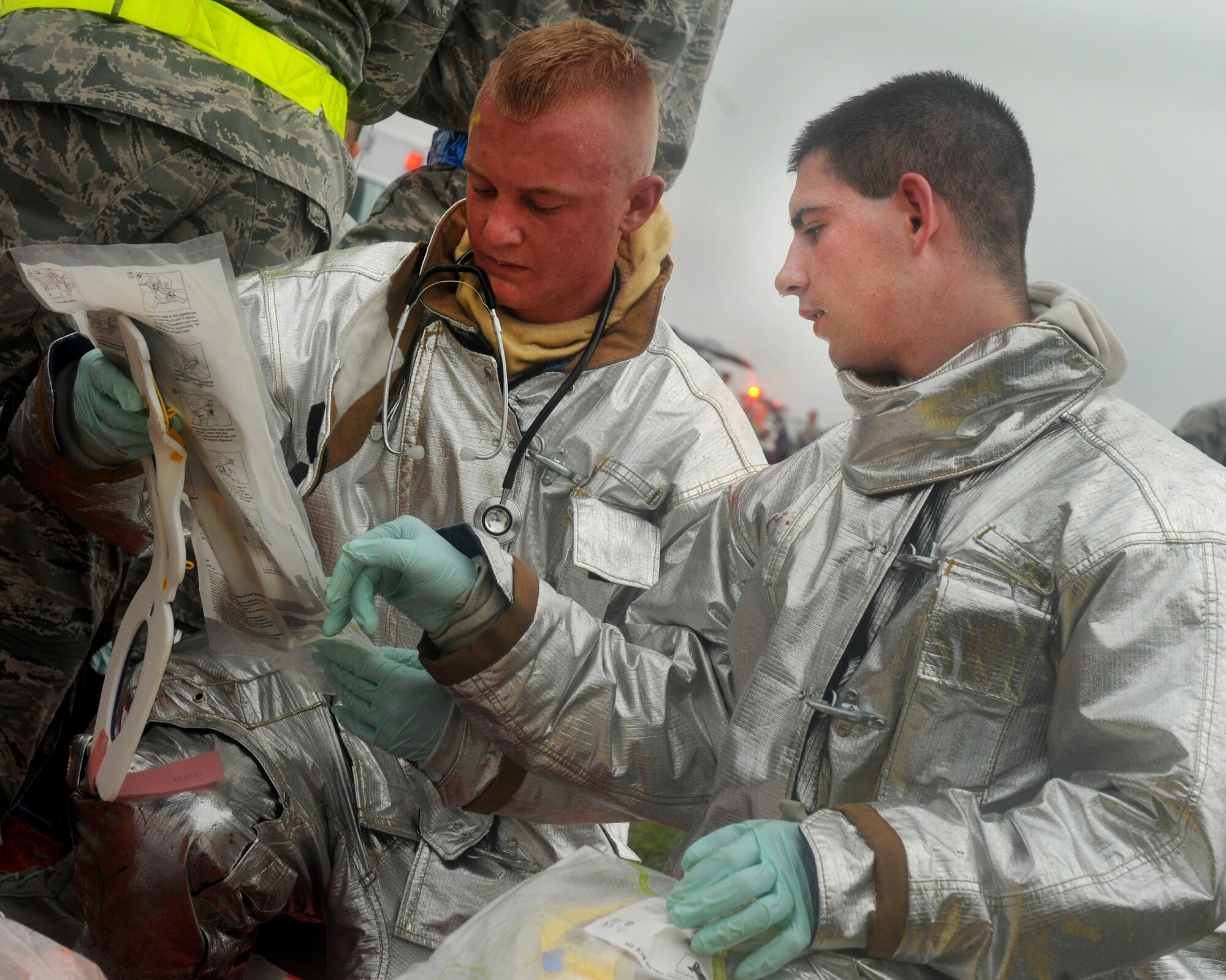 Airmen from the 18th Civil Engineer Squadron’s fire department treat simulated wounded personnel during an emergency management exercise (EME) taking place during local operational readiness exercise Beverly High 12-4 on Kadena Air Base, Japan, May 16, 2012. Evaluations like this EME will be taking place all week to test the skills and knowledge of Kadena’s Airmen to ensure they are ready to respond to contingencies throughout the Pacific command. (U.S Air Force photo/Staff Sgt. Laszlo Babocsi)