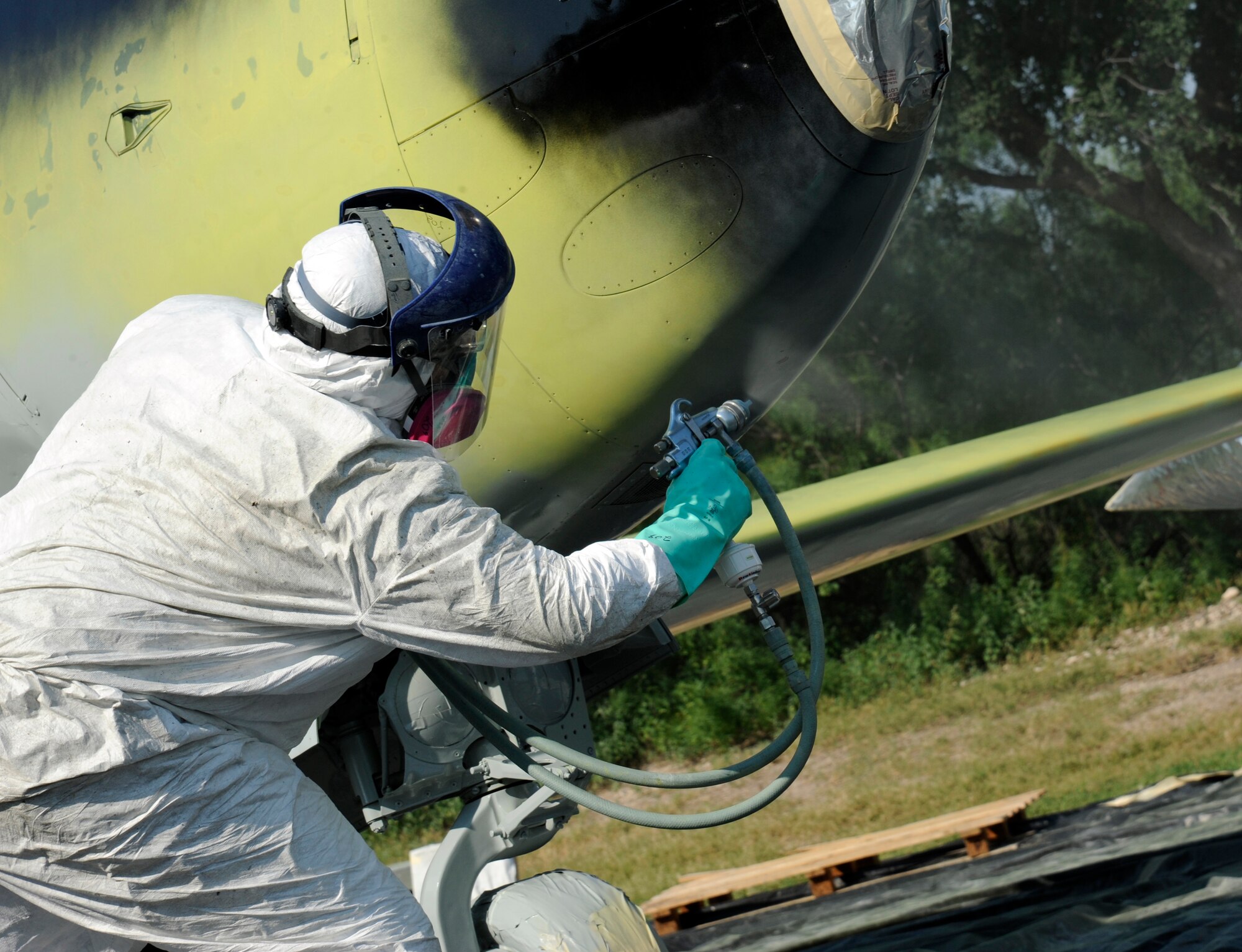 An aircraft painter from the 47th Maintenance Directorate’s Corrosion Control section sprays on the first coat of paint onto the T-33 Shooting Star jet trainer on display at Laughlin Air Force Base, Texas, May 5, 2012. The corrosion control section sets aside a month each year to clean and repair the 11 static aircraft that populate Laughlin’s landscape. (U.S. Air Force photo/Airman 1st Class Nathan Maysonet)