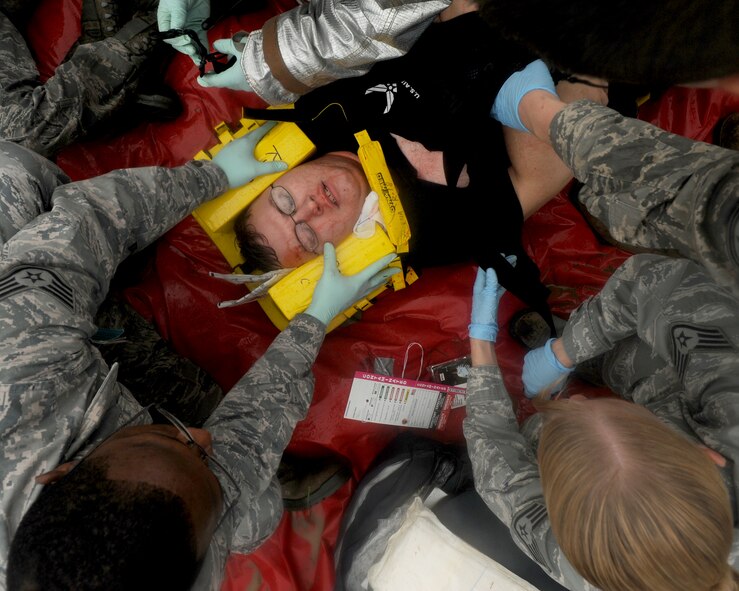 Airmen from the 18th Medical Group and firefighters from the 18th Civil Engineer Squadron treat simulated wounded personnel during an emergency management exercise (EME) taking place during local operational readiness exercise Beverly High 12-4 on Kadena Air Base, Japan, May 16, 2012. Evaluations like this EME will be taking place all week to test the skills and knowledge of Kadena’s Airmen to ensure they are ready to respond to contingencies throughout the Pacific command. (U.S Air Force photo/Staff Sgt. Laszlo Babocsi)