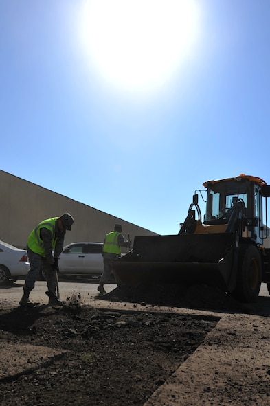 MINOT AIR FORCE BASE, N.D. -- Airman 1st Class Zachary Flowers, 5th Civil Engineer Squadron heavy equipment operator uses a maddox to break up the concrete during a routine road fixture project here May 10. Heavy equipment operators respond to infrastructure emergencies on base, clear roadways, ensure the airfield is clear of debris and holes and keep perimeter roads smooth. (U.S. Air Force photo/Senior Airman Brittany Y. Auld)