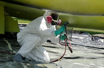 An aircraft painter from the 47th Maintenance Directorate’s Corrosion Control section sprays on paint primer beneath one of the wings of the T-33 Shooting Star jet trainer on display at Laughlin Air Force Base, Texas, May 5, 2012. The corrosion control section sets aside a month each year to clean and repair the 11 static aircraft that populate Laughlin’s landscape. (U.S. Air Force photo/Airman 1st Class Nathan Maysonet)
