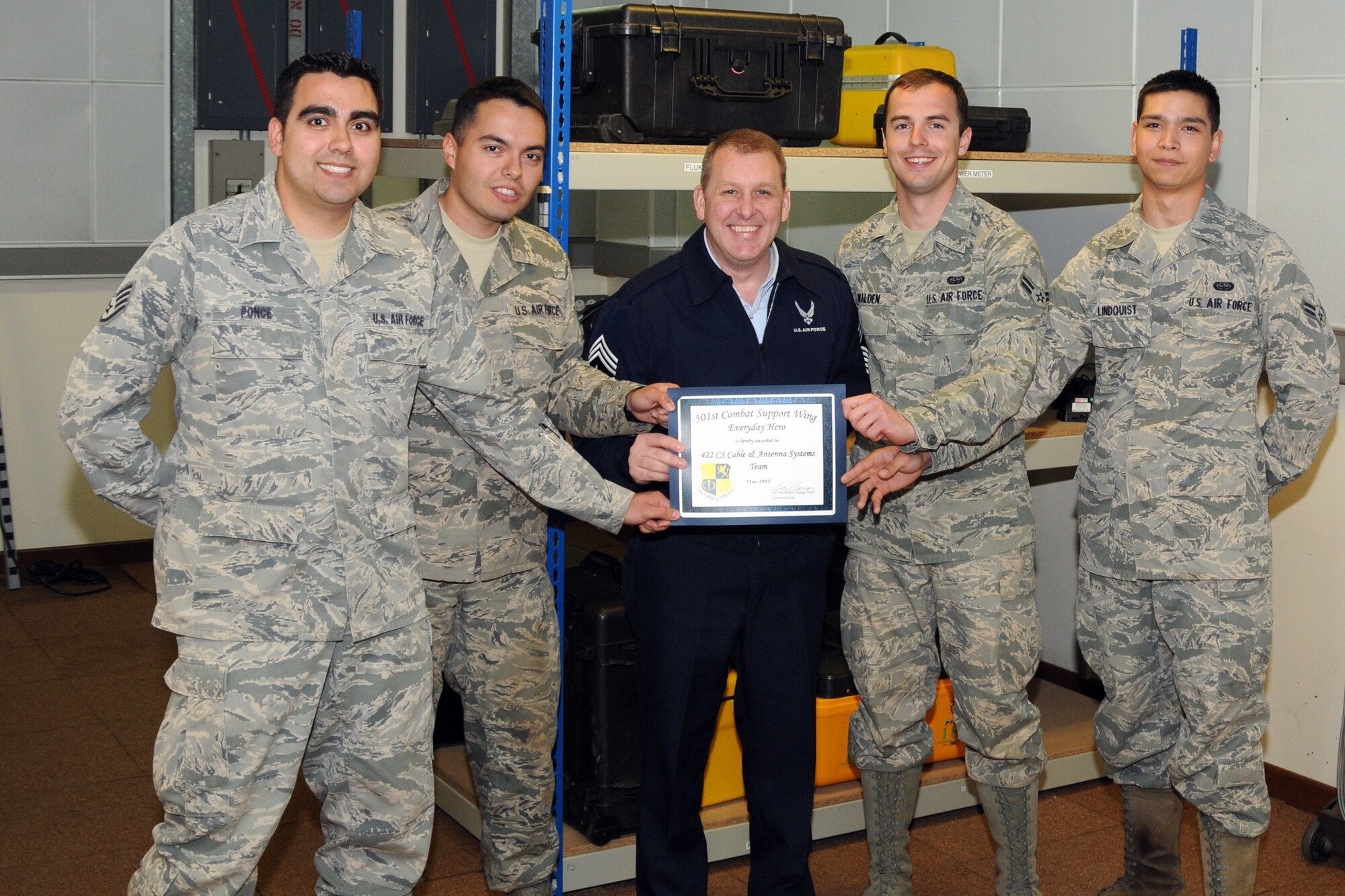 RAF CROUGHTON, United Kingdom - Staff Sgt. Cesar Ponce, Senior Airman John Westover, Airman 1st Class Eric Walden and Airman 1st Class Nicholas Lindquist were named the May 501st Everyday Heroes from the 422nd Air Base Group. The Airmen are assigned to the 422nd Communications Squadron's Cable and Antenna System's team. The team recently saved the government $5,000 in repair fees by fixing an alarm system at RAF Welford. (U.S. Air Force photo by Master Sgt. Randy Hillsgrove)
