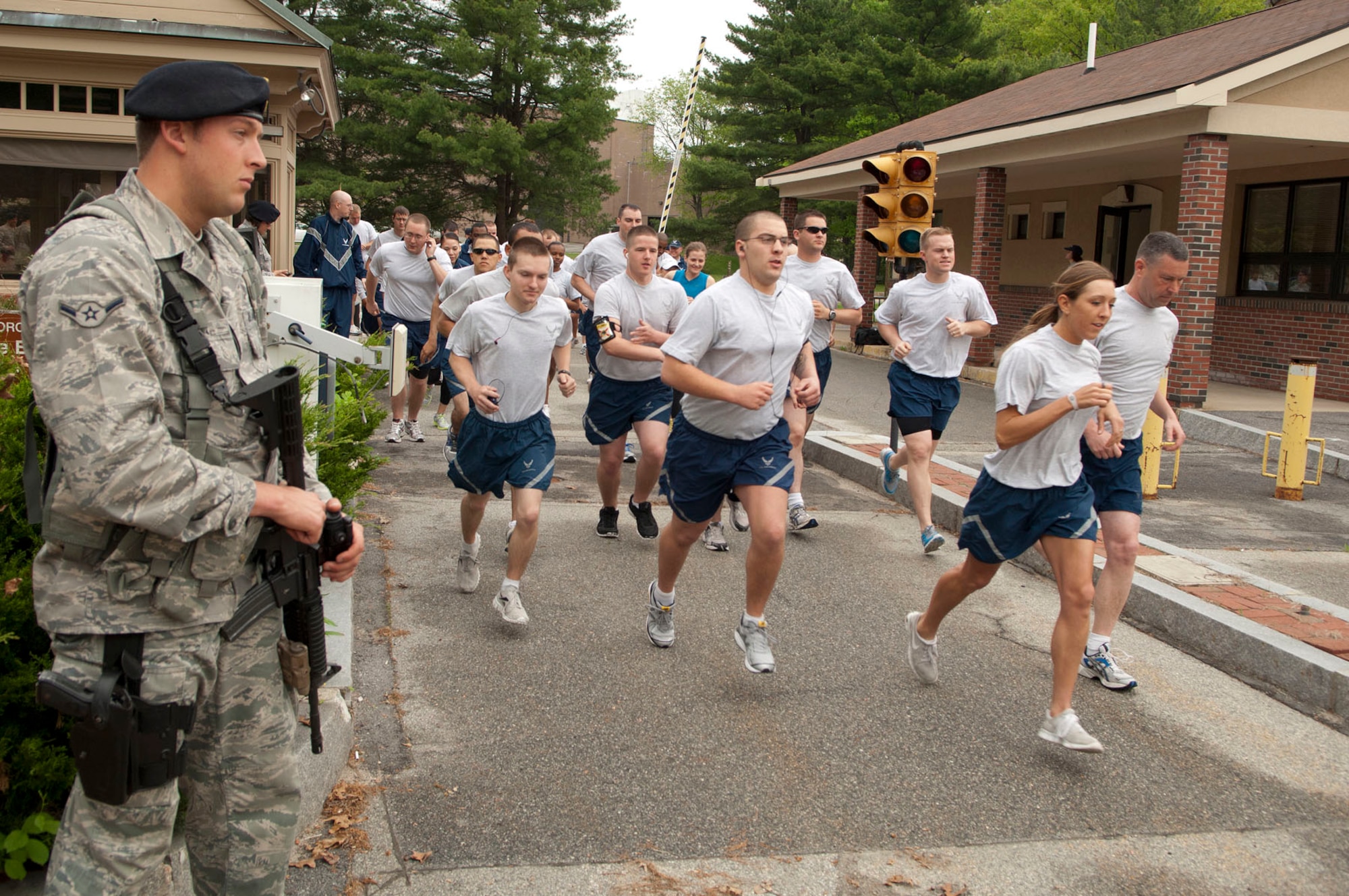 HANSCOM AIR FORCE BASE, Mass. - Airman Seth Kennedy stands guard at Gate 2 as runners exit the base for the Police Week 5K through Minute Man National Historical Park May 14. The 66th Security Forces Squadron hosted several demonstrations, events and activities for Police Week May 14 through 18. Look for more photos of Police Week in next week’s Hansconian. (U.S. Air Force photo by Mark Wyatt)