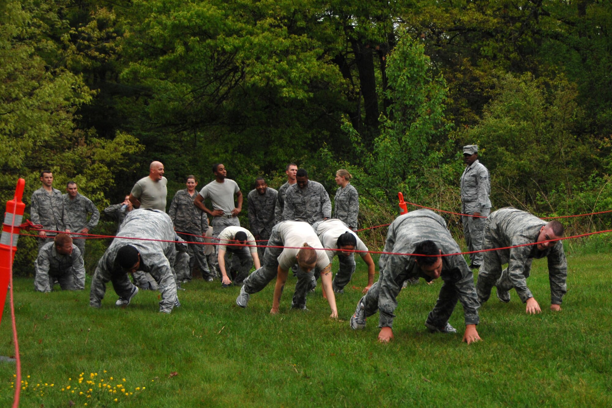 HANSCOM AIR FORCE BASE, Mass. – Airmen crawl through an obstacle during Warrior Day May 9. Members of the 66th Air Base Group participated in several obstacles across the base as part of their physical fitness time. (U.S. Air Force photo by Linda LaBonte Britt)
