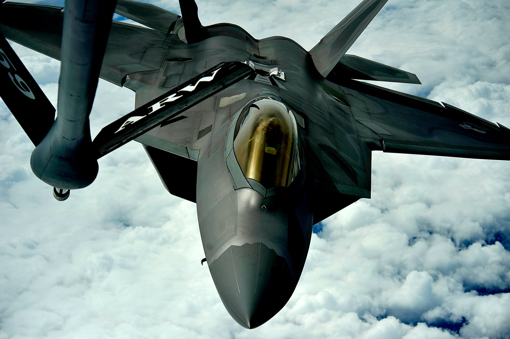 A 1st Fighter Wing's F-22 Raptor from Joint Base Langley-Eustis, Va. pulls into position to accept fuel from a KC-135 Stratotanker with the 756th Air Refueling Squadron, Joint Base Andrews Naval Air Facility, Md. off the east coast on May 10, 2012. The first Raptor assigned to the Wing arrived Jan. 7, 2005. This aircraft was allocated as a trainer, and was docked in a hanger for maintenance personnel to familiarize themselves with its complex systems. The second Raptor, designated for flying operations, arrived Jan. 18, 2005. On Dec. 15, 2005, Air Combat Command commander, along with the 1 FW commander, announced the 27th Fighter Squadron as fully operational capable to fly, fight and win with the F-22. (U.S. Air Force Photo by: Master Sgt. Jeremy Lock) (Released)
