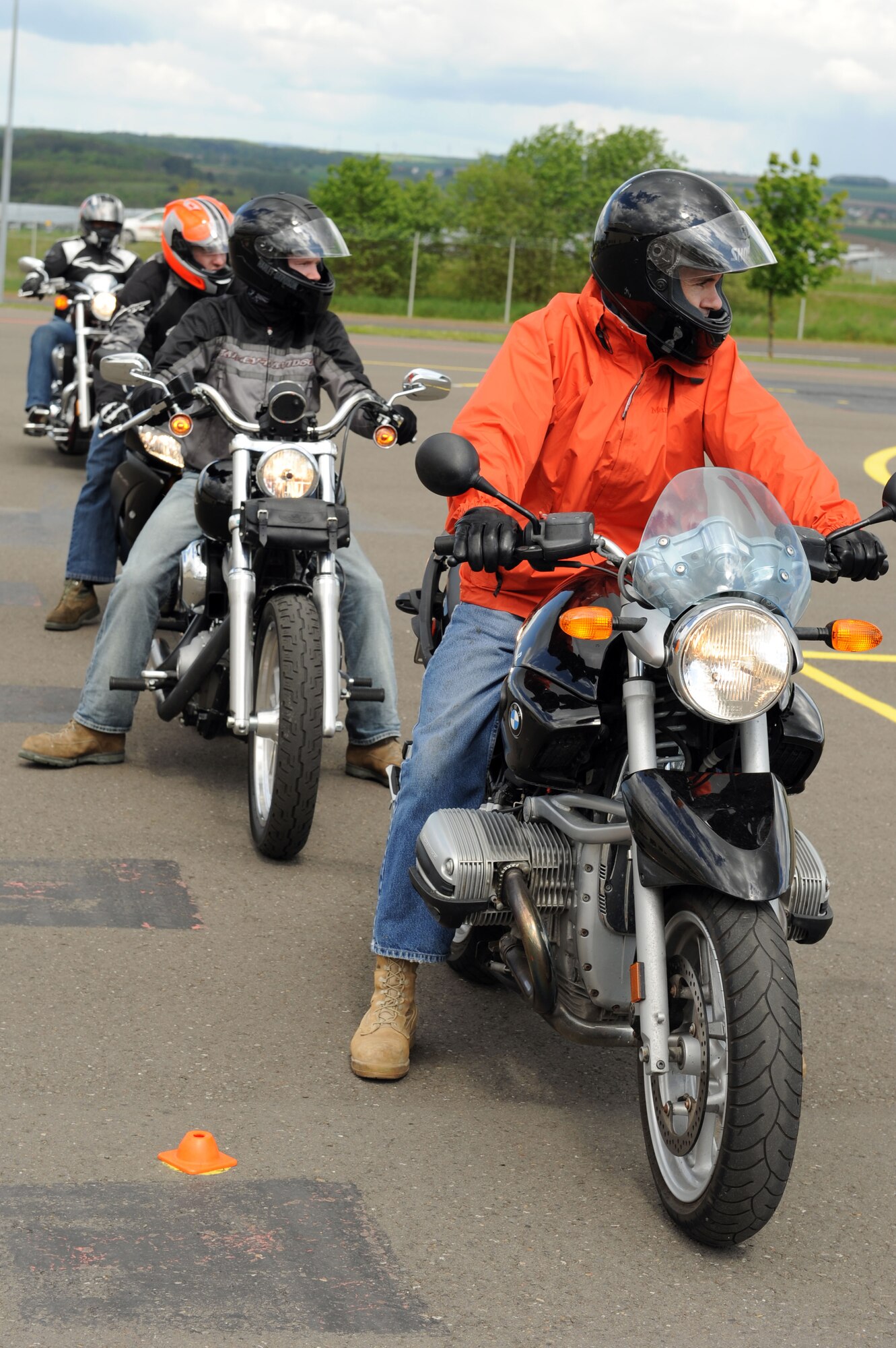 SPANGDAHLEM AIR BASE, Germany – Motorcycle riders wait for their turn to execute maneuvers during a motorcycle safety class at the Saber driving course here May 15. The course participants practiced maneuvers to include path of travel, quick stops and obstacle avoidance. The class is geared to improve riders’ skill by performing different maneuvers on the course as well as discussing and reviewing a variety of safety information. The 52nd Fighter Wing Safety office conducts the motorcycle safety course three times monthly. U.S Air Forces in Europe regulations mandate that every motorcyclist on base must take or retake this class once every three years to keep their skillset current. (U.S. Air Force photo by Senior Airman Christopher Toon/Released)