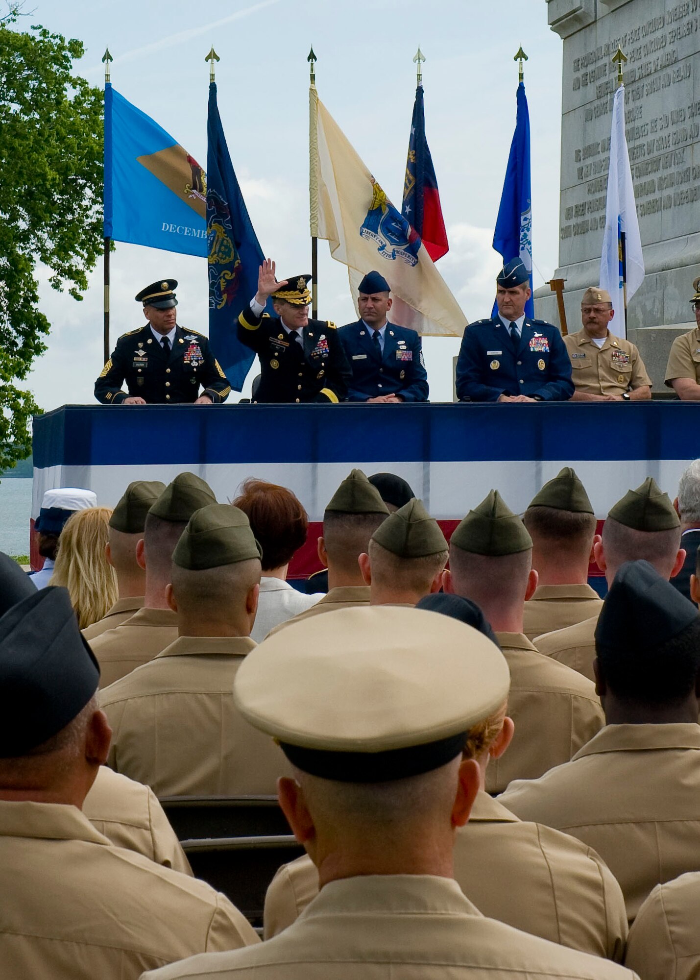 U.S. Army Maj. Gen. Bradley W. May, commanding general of the Army's Initial Military Training Center of Excellence, waves during his introduction during the Joining Forces’ Honoring Members and Families event May 15, 2012 at the Yorktown Victory Monument at Colonial National Historical Park in Yorktown, Va. While the America the Beautiful National Parks and Federal Recreation Lands Annual Pass is not available for free to veterans and retirees, many of these individuals are eligible for other discounted passes, such as the Senior Pass, granting lifetime access to U.S. citizens over 62 for $10, and the Access Pass granting free lifetime access for permanently disabled U.S. Citizens. (U.S. Air Force photo by Senior Airman John D. Strong II/Released)