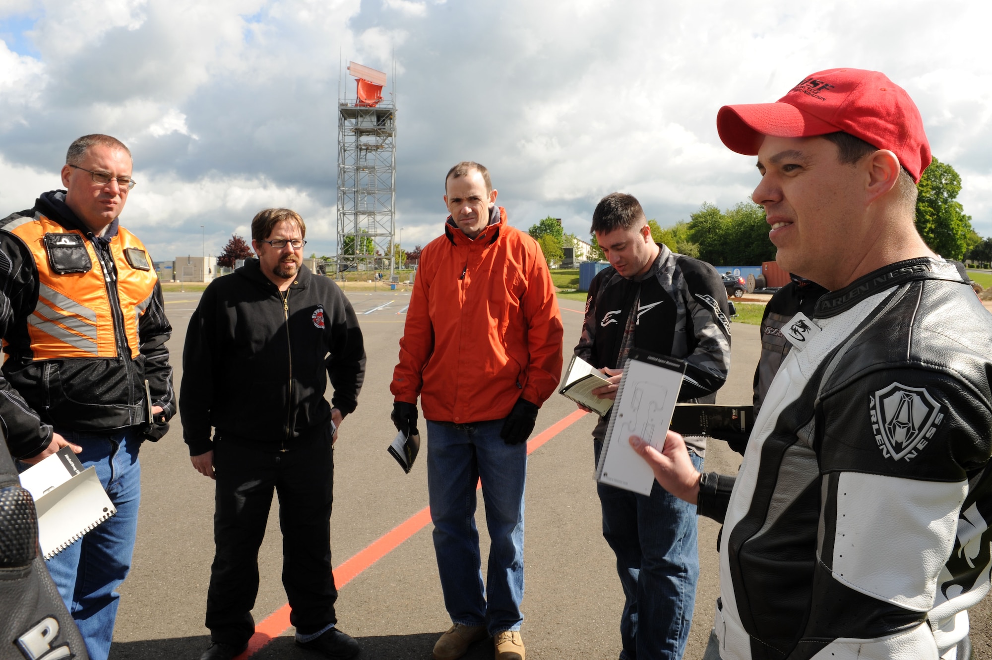 SPANGDAHLEM AIR BASE, Germany – Right, Master Sgt. Douglas Cook, 52nd Fighter Wing Safety office and motorcycle instructor, discusses safety material during the motorcycle safety class at the Saber driving course here May 15. The class is geared to improve riders’ skill by performing different maneuvers on the course as well as discussing and reviewing a variety of safety information. The safety office conducts the motorcycle safety course three times monthly. U.S Air Forces in Europe regulations mandate that every motorcyclist on base must take or retake this class once every three years to keep their skillset current.  (U.S. Air Force photo by Senior Airman Christopher Toon/Released)