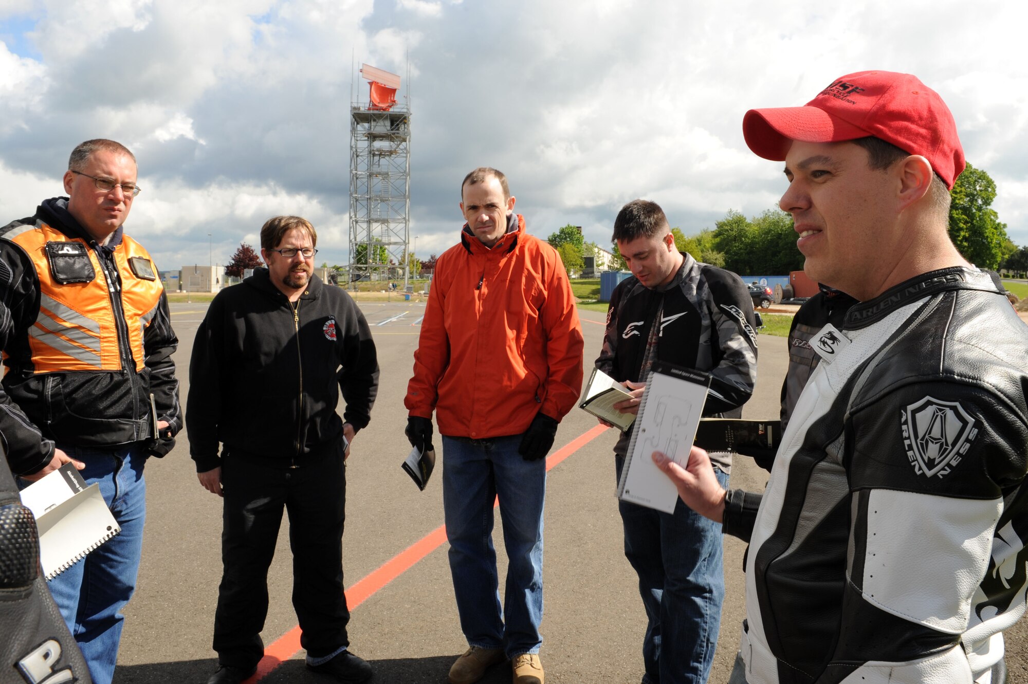 SPANGDAHLEM AIR BASE, Germany – Right, Master Sgt. Douglas Cook, 52nd Fighter Wing Safety office and motorcycle instructor, discusses safety material during the motorcycle safety class at the Saber driving course here May 15. The class is geared to improve riders’ skill by performing different maneuvers on the course as well as discussing and reviewing a variety of safety information. The safety office conducts the motorcycle safety course three times monthly. U.S Air Forces in Europe regulations mandate that every motorcyclist on base must take or retake this class once every three years to keep their skillset current.  (U.S. Air Force photo by Senior Airman Christopher Toon/Released)