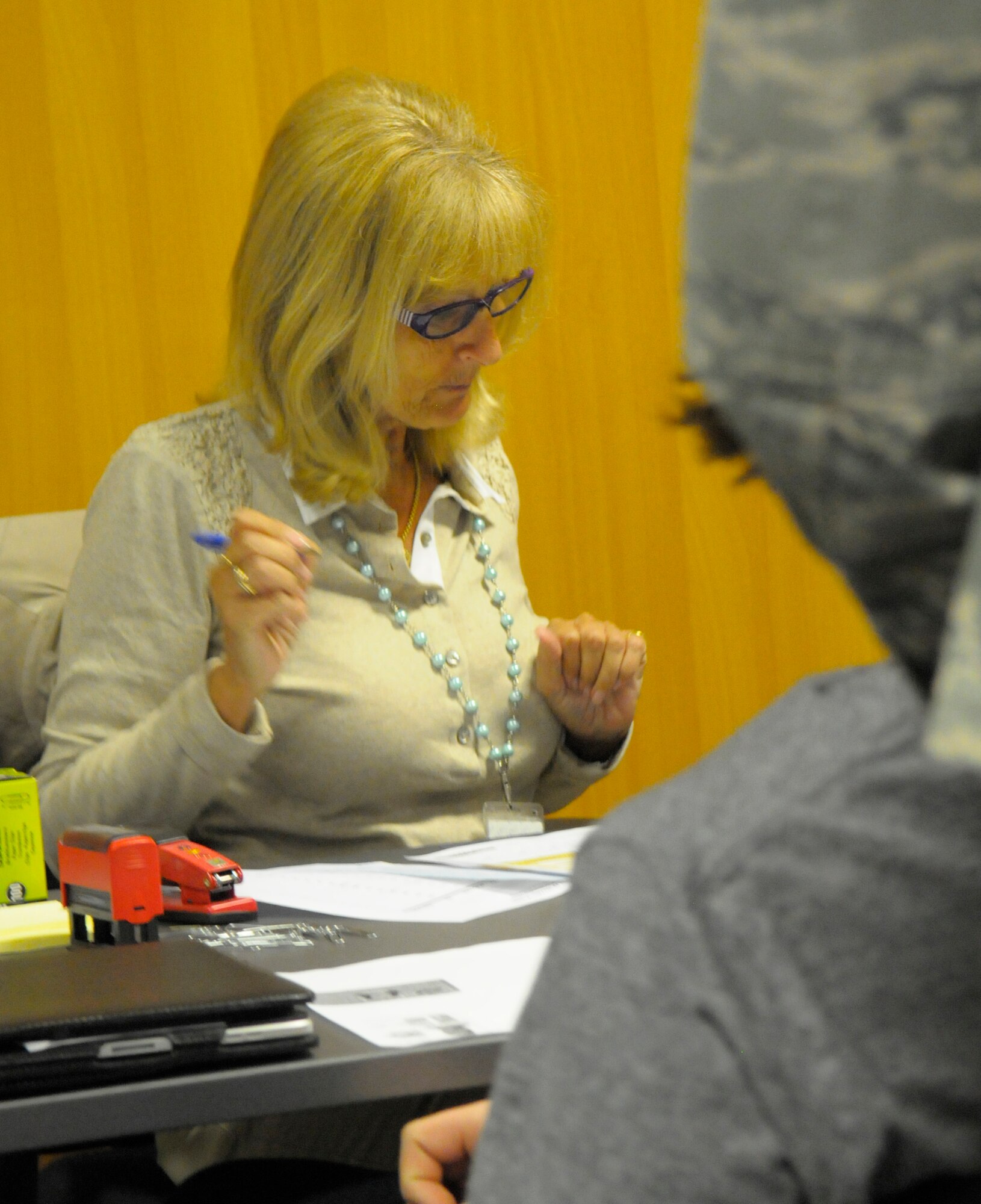 Cindy Foster, Frankfurt American Consulate office passport assistant supervisor, verifies info on a tourist passport application for a family preparing for vacation May 16, 2012 on Ramstein Air Base. The Consulate General's office from Frankfurt was on hand to help mass process passport and report of birth applications for Kaiserslautern Military Community service members and their families. (U.S. Air Force photo/Staff Sgt. Travis
Edwards)
