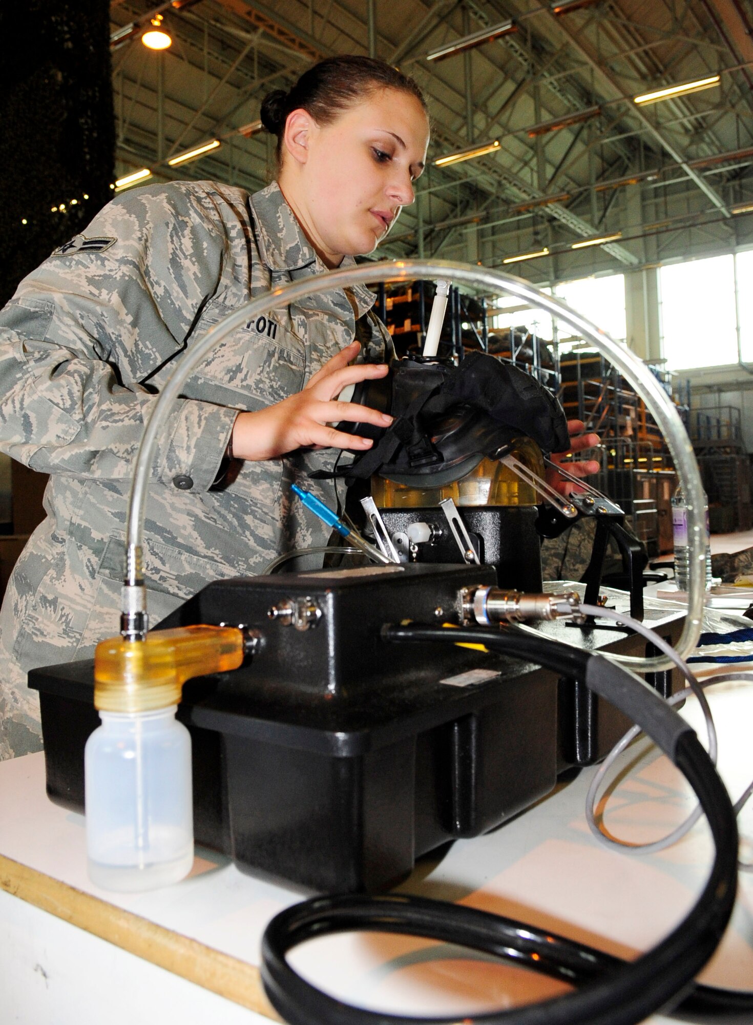 RAF MILDENHALL, England – Airman 1st Class Lisa Foti, 100th Logistics Readiness Squadron individual protective equipment journeyman, performs a quality check on an M50 gas mask here May 15, 2012. Unlike the MCU-2/P gas mask, the newer M50 model offers a wider field of view, minimized breathing resistance and two chemical filters. (U.S. Air Force photo/Senior Airman Ethan Morgan)