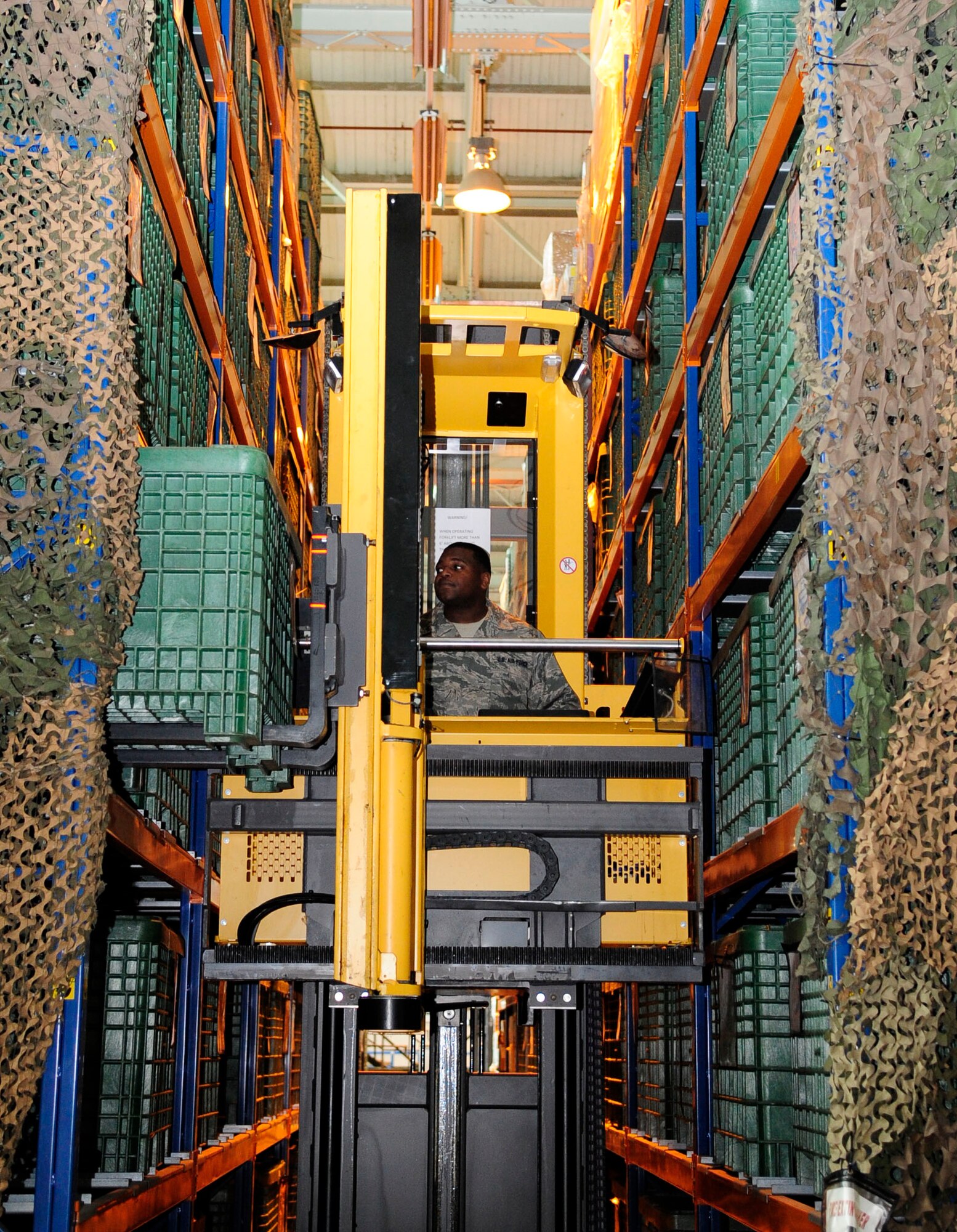 RAF MILDENHALL, England – Staff Sgt. Valent Anderson, 100th Logistics Readiness Squadron individual protective equipment craftsman, uses material-handling equipment to store a bin filled with chemical warfare defense equipment here May 15, 2012. The equipment is stored in a bin row until it is needed for deploying Airmen. (U.S. Air Force photo/Senior Airman Ethan Morgan)