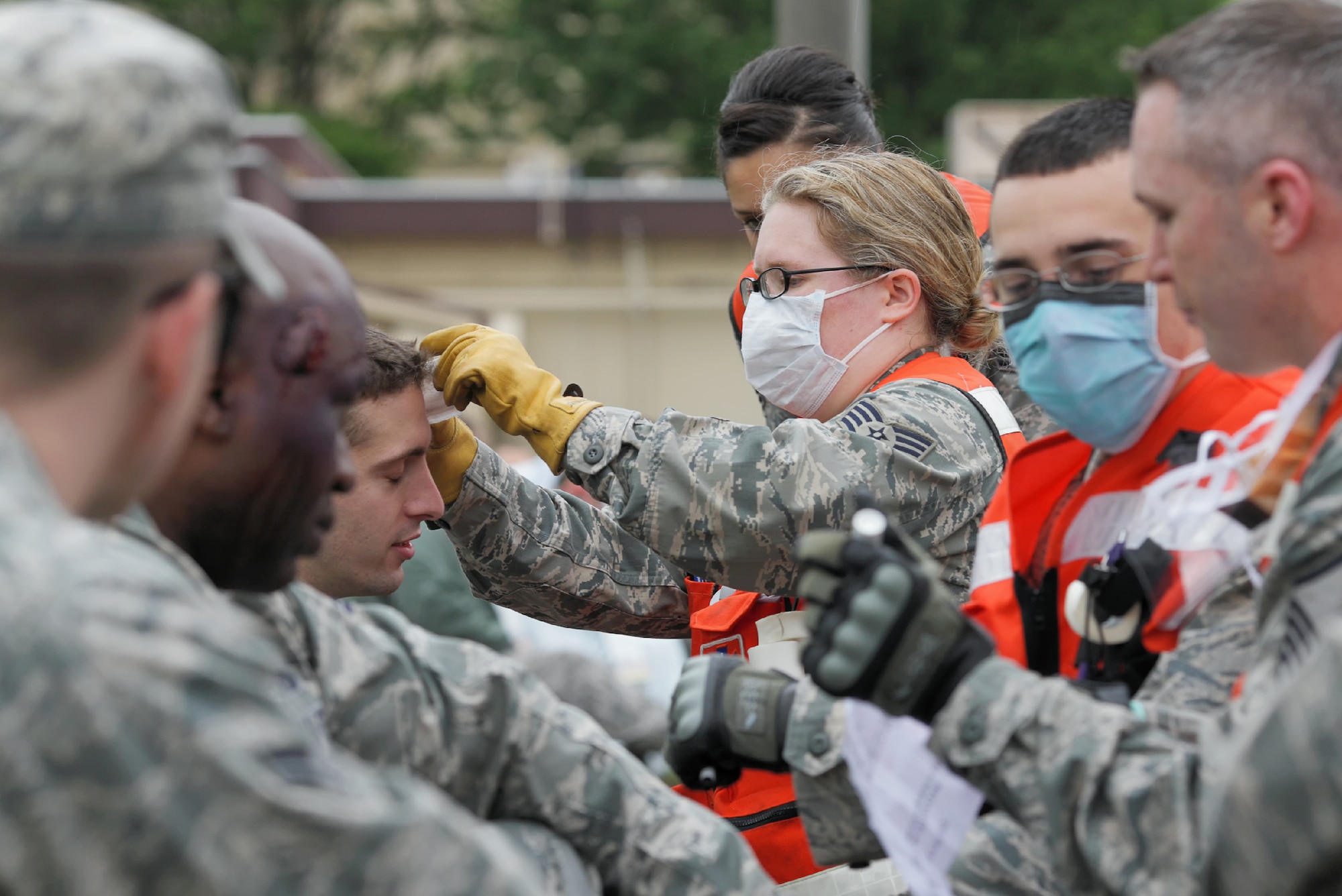 YOKOTA AIR BASE, Japan -- Airmen from the 374th Medical Group perform self-aid and buddy care during the Emergency Management Exercise portion of the Consolidated Unit Inspection at Yokota Air Base, Japan, May 15, 2012. Self-aid and buddy care is performed on victims with simulated injuries during the EME to ensure the medical technicians are proficient. (U.S. Air Force photo by Osakabe Yasuo)  