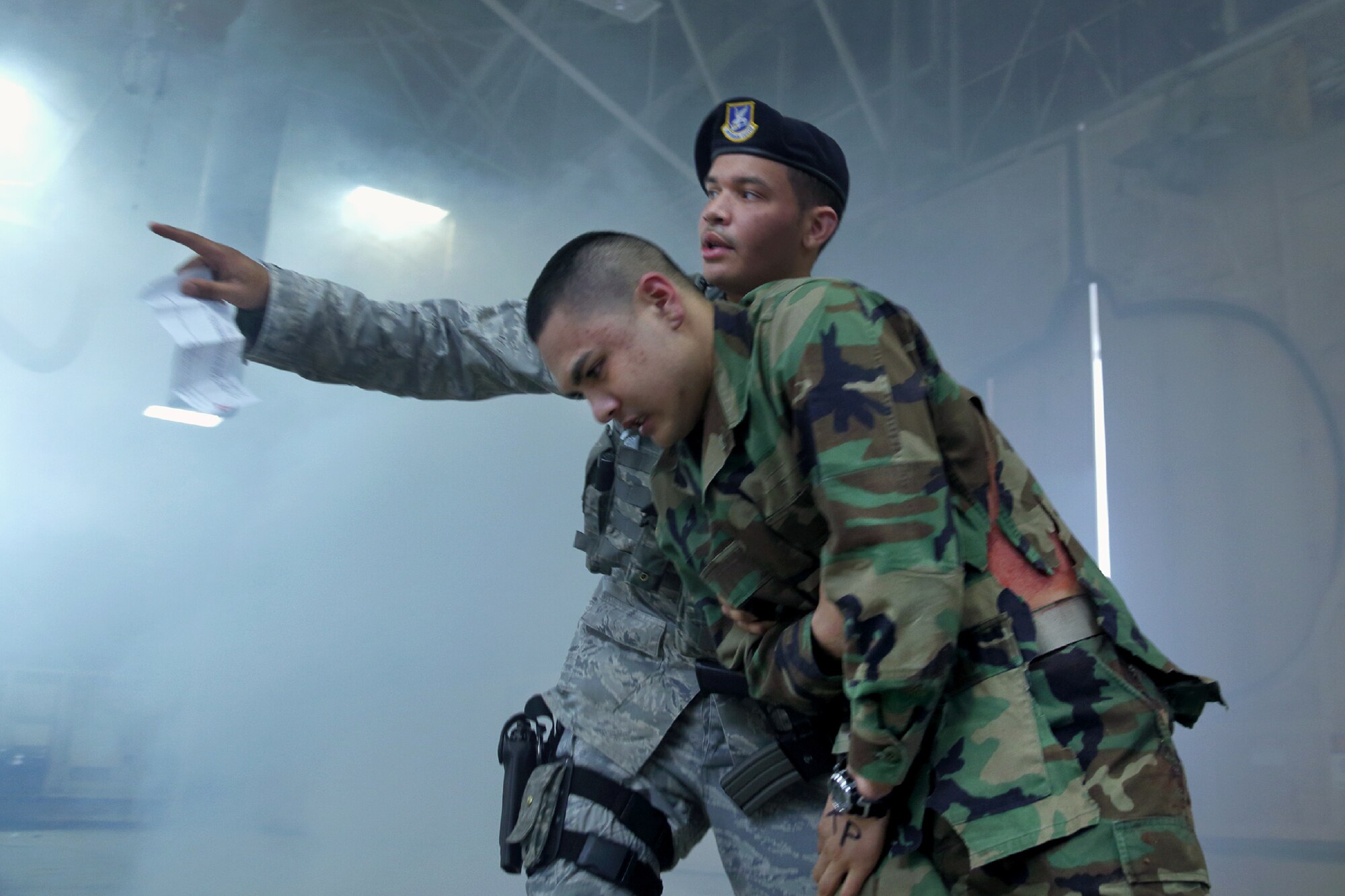YOKOTA AIR BASE, Japan -- Senior Airman Hasson Frederickson, 374th Security Forces Squadron patrolman, guides an Airman with a simulated injury to safety during the Emergency Management Exercise portion of the Consolidated Unit Inspection at Yokota Air Base, Japan, May 15, 2012. The CUI inspects operational readiness and unit compliance on a two-year rotational basis. (U.S. Air Force photo by Osakabe Yasuo)