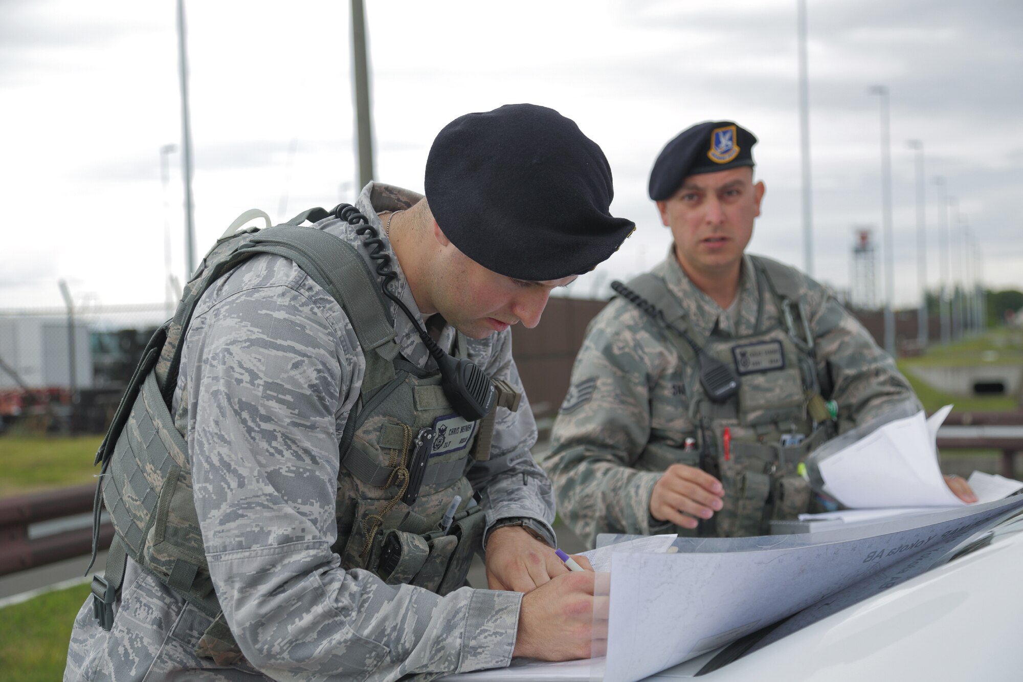 YOKOTA AIR BASE, Japan -- 1st Lt. Chris Heinen, left, and Staff Sgt. Carlos Sanchez, right, both from the 374th Security Forces Squadron, set up the entry control point during an exercise scenario during the Consolidated Unit Inspection at Yokota Air Base, Japan, May 15, 2012. Security Forces sets up control points to ensure the accident scene is kept safe and secure. (U.S. Air Force photo by Osakabe Yasuo)  