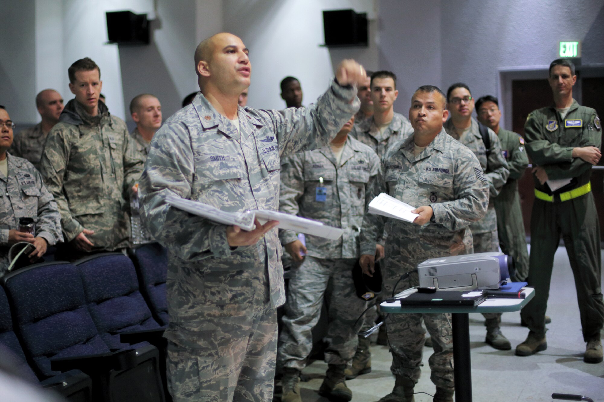 YOKOTA AIR BASE, Japan -- Maj. Jeffrey Smith, center, 374th Airlift Wing exercises and inspections chief, explains an Emergency Management Exercise scenario to an exercise evaluation team during the Consolidated Unit Inspection at Yokota Air Base, Japan, May 15, 2012. The CUI examines how Yokota's programs, plans and procedures follow Air Force Instruction and Department of Defense directives. (U.S. Air Force photo by Osakabe Yasuo)