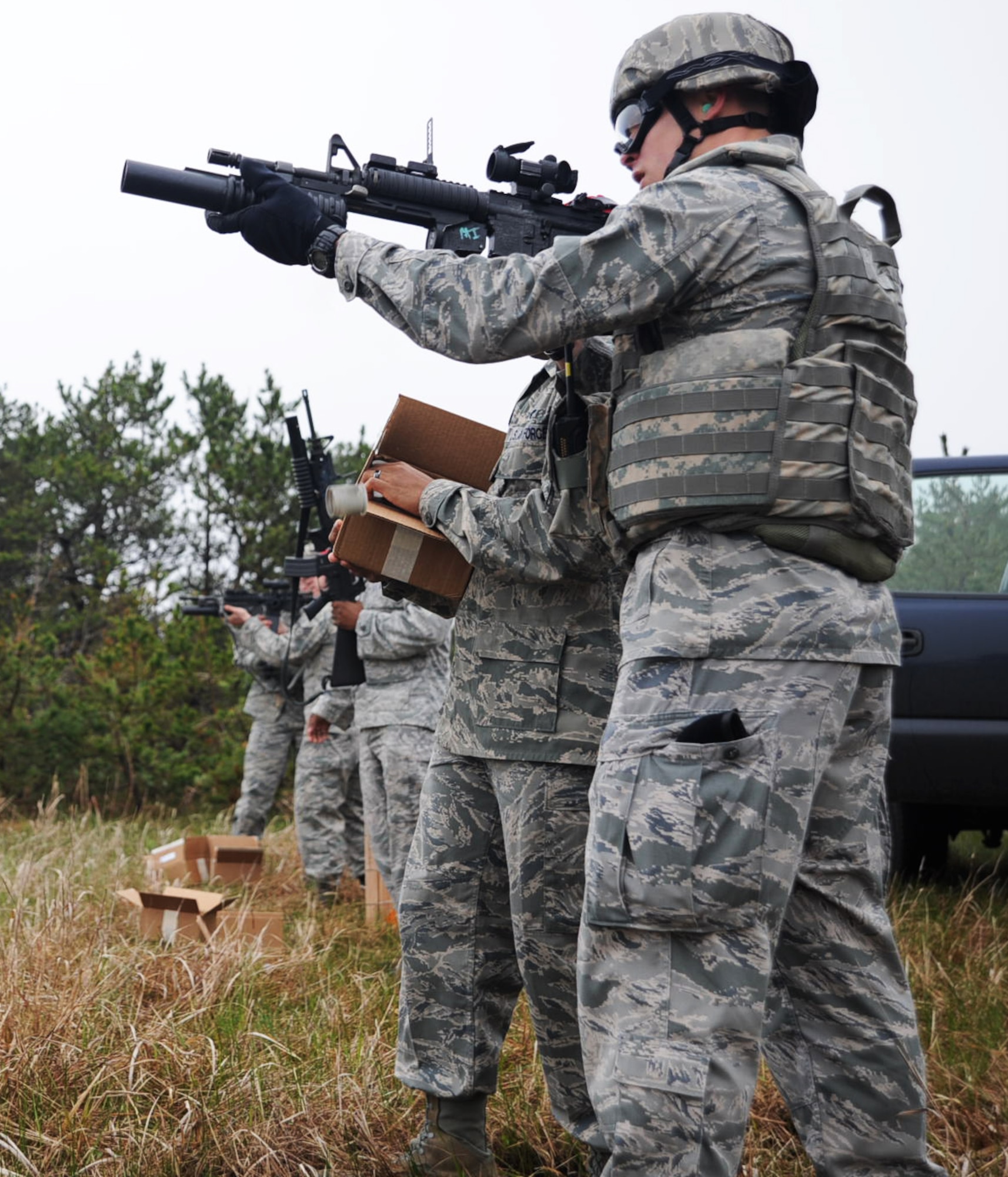 U.S. Airmen from the 35th Security Forces Squadron fire M203 grenade launchers during qualification training at Draughon Range, Japan, May 16, 2012. A total of nine Airmen were on the range to maintain their deployment readiness and proficiency in weapon use. (U.S. Air Force photo by Airman Kenna Jackson/Released)