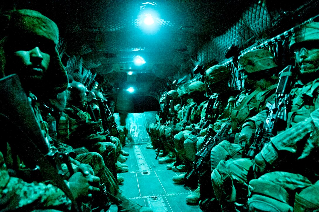 As seen through a night-vision device, U.S. Army paratroopers and Afghan soldiers travel aboard a CH-47 Chinook helicopter during an air assault mission in Afghanistan's Ghazni province, May 4, 2012. 