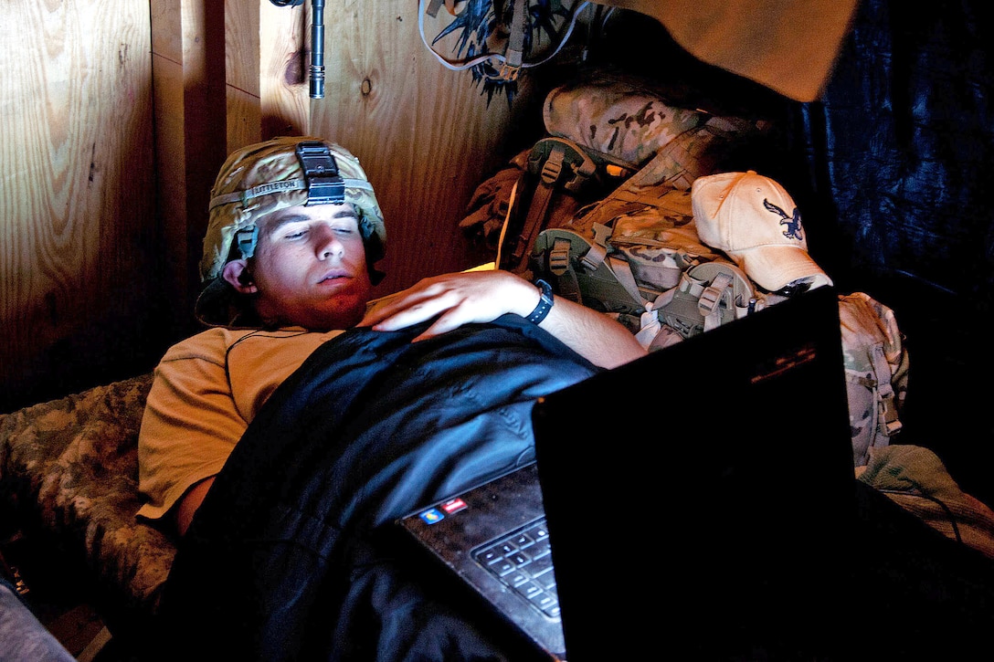 U.S. Army Spc. Zeke Littleton watches a movie in his barracks on ...