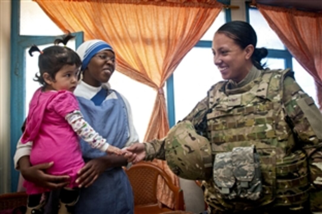 U.S Air Force Staff Sgt. Shirly Polk chats with Maria, 4, during a donation mission at the Mother Teresa Orphanage in Kabul, Afghanistan, May 10, 2012. Polk is a member of the International Security Assistance Force headquarters volunteer community relations program, which distributes donations, supplies and clothes to area organizations for residents.