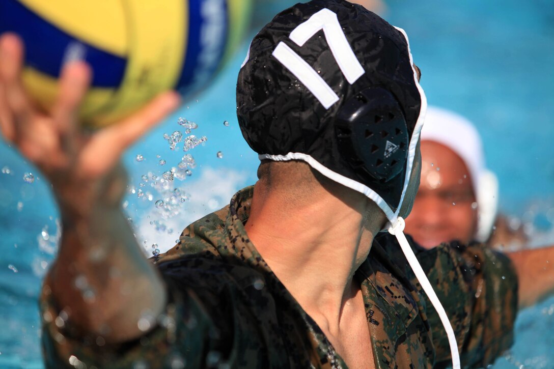 A Camp Pendleton Marine scans the water, searching for a teammate to pass to during a combat water polo game, May 16, at Camp Pendleton’s 13 Area Pool. Combat water polo was modified from the traditional sport of water polo to provide Marines and sailors the increased safety of a shallow playing field while maintaining the difficulty by adding combat boots and utilities.