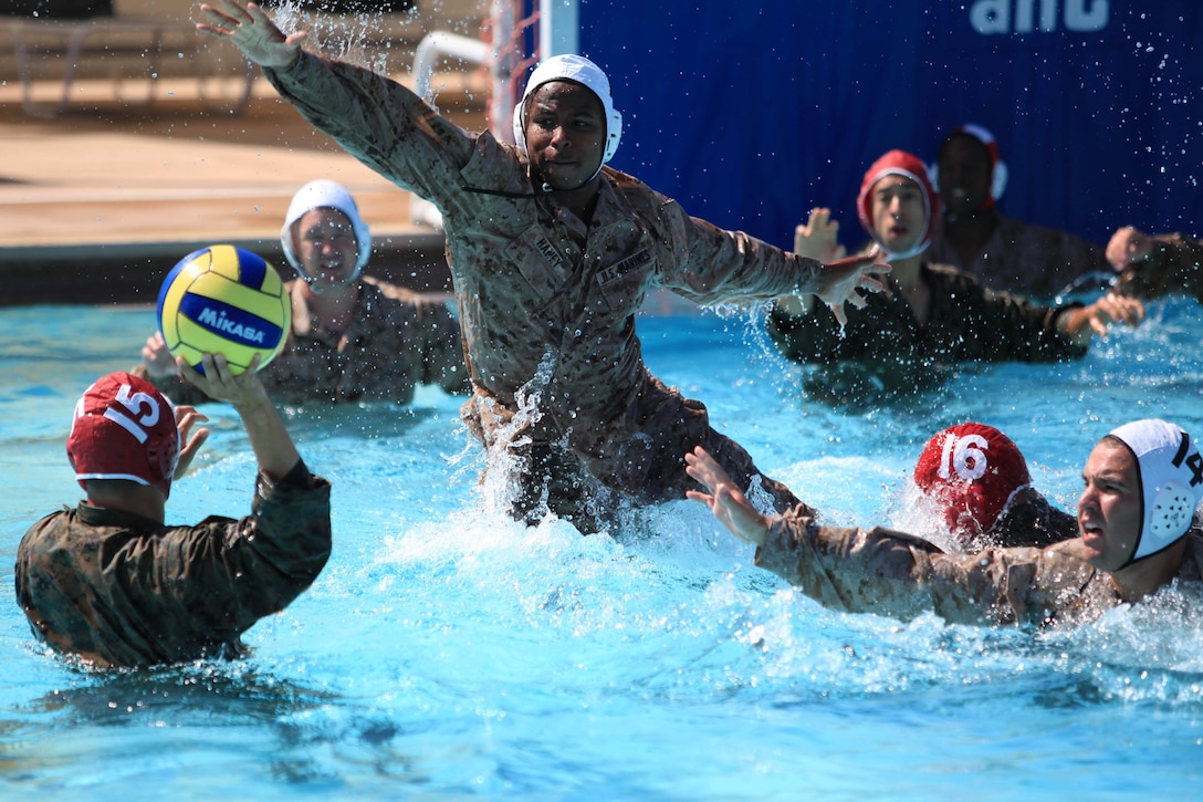 Thaddaeus I. Haney explodes upward and out of the water in an attempt to block an opponent’s pass during a combat water polo game, May 16 at Camp Pendleton’s 13 Area Pool. Combat water polo was modified from the traditional sport of water polo to provide Marines and sailors the increased safety of a shallow playing field while maintaining difficulty by adding combat boots and utilities.