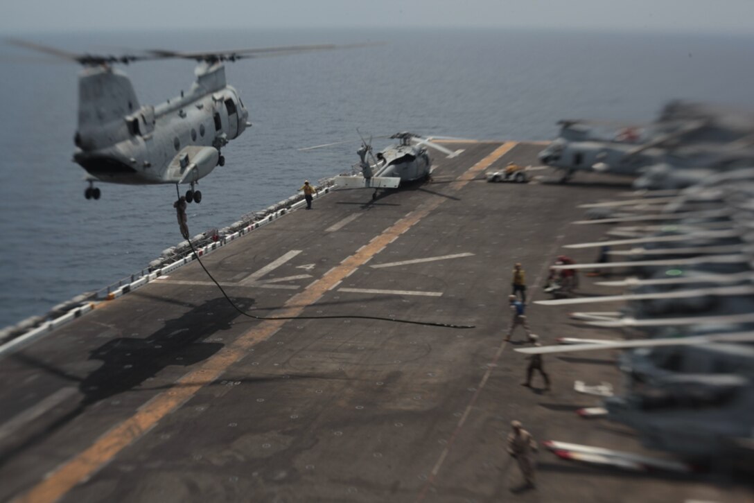 A Marine with Company I descends down a thick, plaited rope rigged to a CH-46E Sea Knight flown by pilots with Marine Medium Helicopter Squadron 268 (Reinforced) onto USS Makin Island's flight deck here May 16. The company is one of three rifle companies in Battalion Landing Team 3/1, the ground combat element for the 11th Marine Expeditionary Unit. The unit embarked the ship, as well as USS New Orleans and USS Pearl Harbor in San Diego Nov. 14, beginning a seven-month deployment to the Western Pacific, Horn of Africa and Middle East regions.