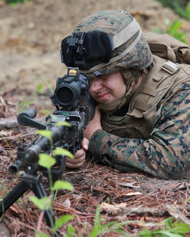 Pfc. Dillon R. Carter from East Haddam, Conn., machine gunner, India Company, 3rd Battalion, 2nd Marine Regiment, 2nd Marine Division, scans the tree-line from his fighting hole during a battalion field exercise May 16. The week-long training operation focused on the evaluation of small unit leaders and their teams in order to set the foundation for building stronger squads. (Official U.S. Marine Corps photo by: Cpl. Andrew D. Johnston)