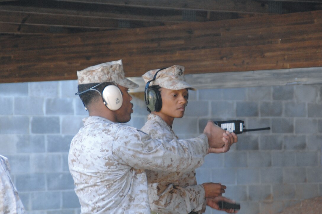 Maj. Latresa Steward, right, receives firing tips from Sgt. Nicholas McMorris, range noncommissioned officer-in-charge, Marine Corps Logistics Base Albany, to help hit her target.