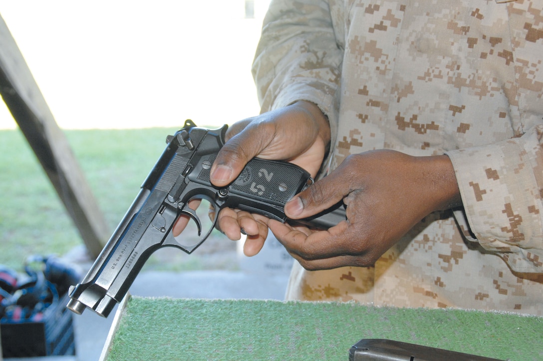 Gunnery Sgt. Kejuan Hull loads his Beretta M9 at MCLB Albany's Recreational Pistol Range, recently.