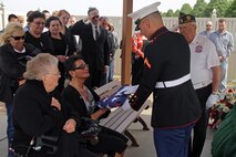 Pfc. Joseph Hauer, 19, from Lino Lakes, Minn., presents an American flag to his mother, Liz, during a funeral service for his father at Fort Snelling National Cemetery May 16. Hauer's father, Joe, was a Bronze Star and Purple Heart recipient who served in the Marines and completed three tours in Vietnam. Hauer, a Centennial High School graduate, completed boot camp in late 2011 and is currently stationed at Twentynine Palms, Calif., with 3rd Light Armored Reconnaissance Battalion.