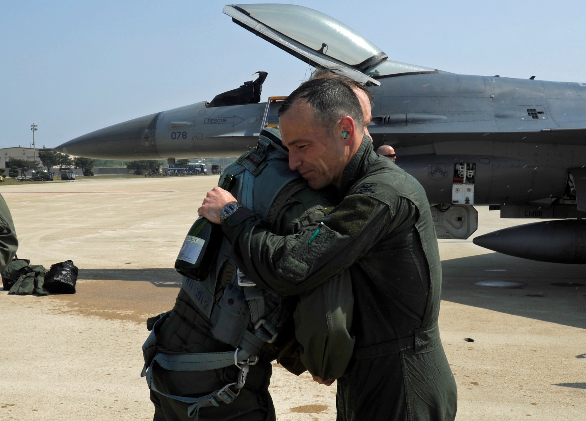Col. Scott L. Pleus, 8th FW commander, hugs Col. Stephen Williams, 8th Fighter Wing vice commander, after Pleus’ final flight as the wing commander of the Wolf Pack on Kunsan Air Base, Republic of Korea, May 16, 2012. (U.S. Air Force photo/Senior Airman Jessica Hines)