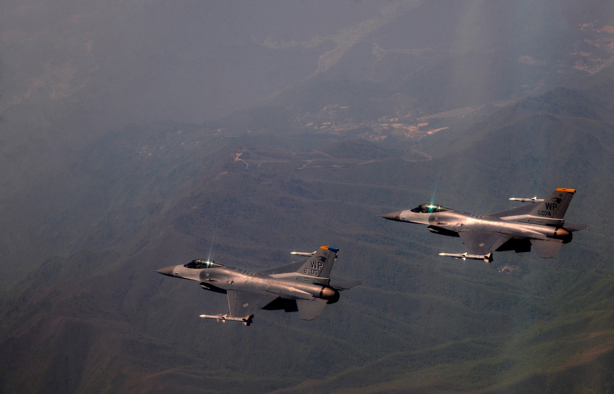 Col. Stephen C. Williams, 8th Fighter Wing vice commander flies alongside Col. Scott L. Pleus, 8th Fighter Wing commander, in their F-16 Fighting Falcons at Kunsan Air Base, Republic of Korea, May 16, 2012. It was Pleus's final flight as the wing commander of the Wolf Pack. Colonel Pleus will relinquish command of the 8 FW May 18. (U.S. Air Force photo/Staff Sgt. Rasheen A. Douglas)