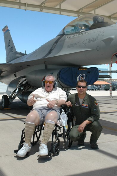 Lt. Col. Scott Reinhold and Bill Englund, a hospice patient from Phoenix, watch F-16 Fighting Falcons taxi by on the 162nd Fighter Wing flightline at Tucson International Airport, May 17. Reinhold worked with the Phoenix-based Bucket List Foundation to help give Englund a ‘pilot for a day’ experience. (U.S. Air Force photo/Maj. Gabe Johnson)