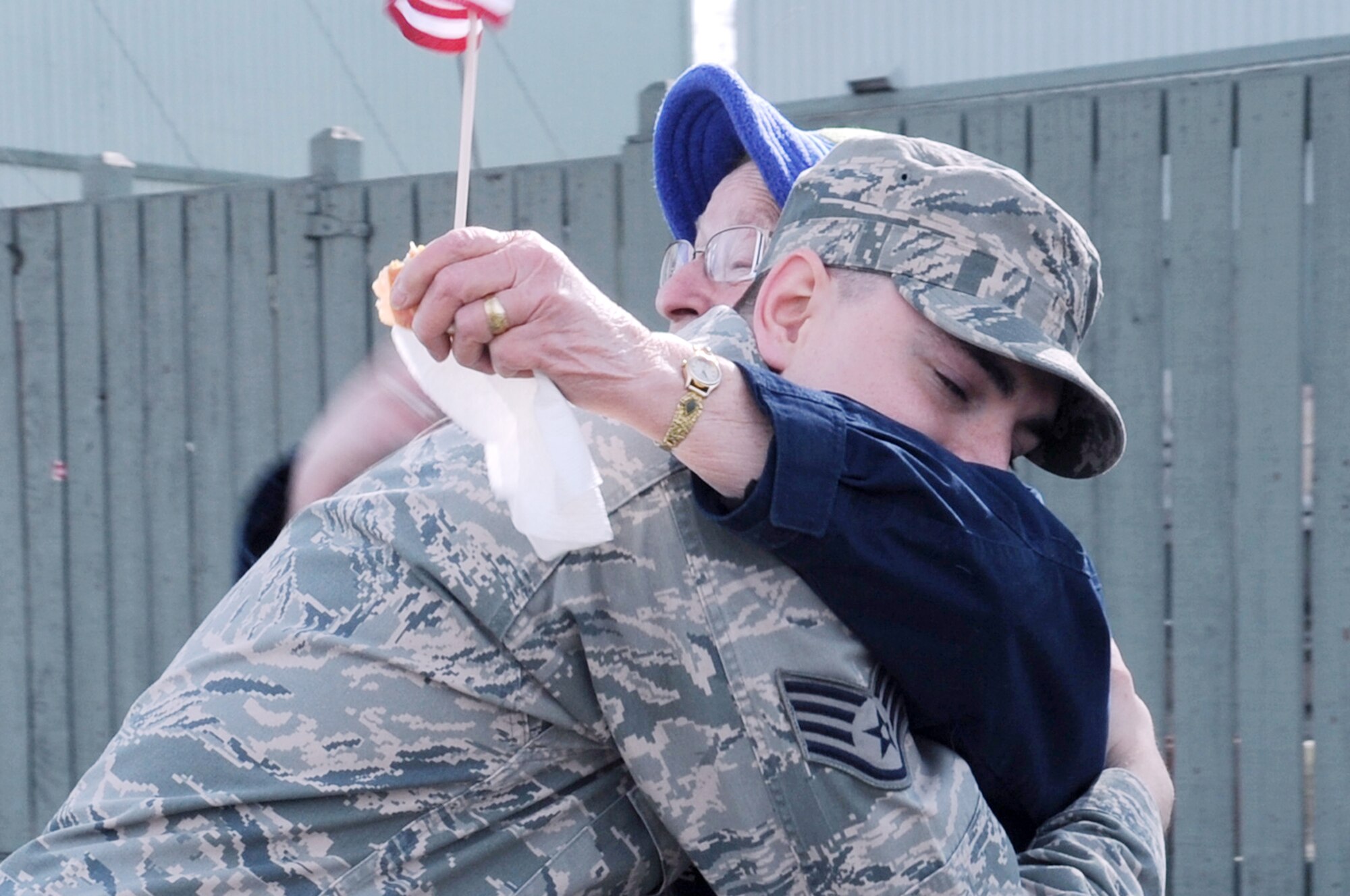 U.S. Air Force Staff Sgt Jacob Worden, 354th Comptroller Squadron NCO in charge of Customer Support, hugs a civilian during the Salute to Our Military Parade May 12, 2012, Fairbanks, Alaska. Worden handed out American flags to viewers along the parade route. (U.S. Air Force photo/Airman 1st Class Lauren-Taylor Garcia)