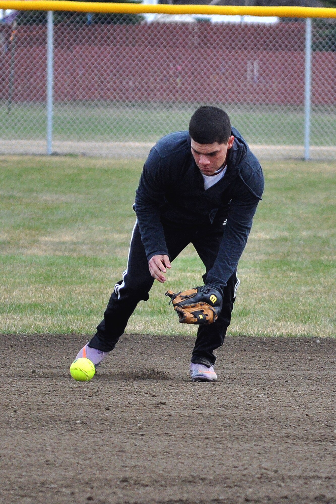 E Troop, 1st Squadron (Airborne), 40th Cavalry Regiment third baseman Steven Mendez chases a ground ball against the 98th Maintenance Company in the first championship game of the JBER-Richardson pre-season softball tournament Saturday. (U.S. Air Force photo/John Pennell)

