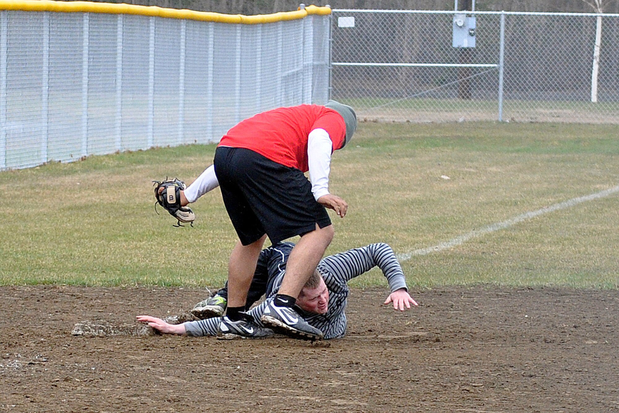 Marcos Juarez, 95th Chemical Company third baseman, tags Taylor Berry, 98th Maintenance Company, in the third-place game of the JBER-Richardson pre-season softball tournament Saturday at Buckner Physical Fitness Center's softball field 2. The 98th Maintenance team cruised past 95th Chemical Company, 20-10, to advance to the tournament championship. (U.S. Air Force photo/John Pennell)